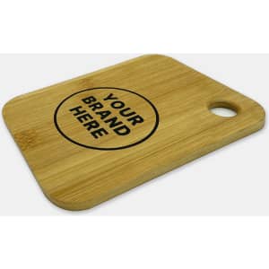A small bamboo cutting board featuring a round cutout and a printed logo in black.