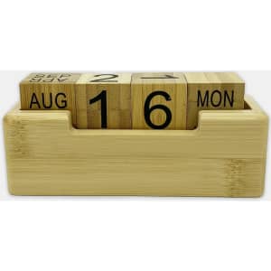 A bamboo perpetual calendar with wooden blocks displaying the date and month, housed in a rectangular base.