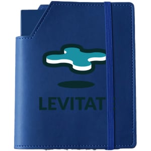 A blue leatherette notebook cover with an elastic band and a logo on the front.