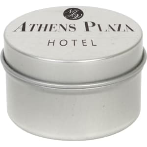 A silver tin candle with a smooth surface, featuring a logo and text for the Athens Plaza Hotel.