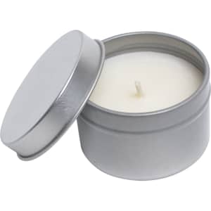 A vanilla scented candle in a silver tin with a removable lid, featuring a plain white wax finish.