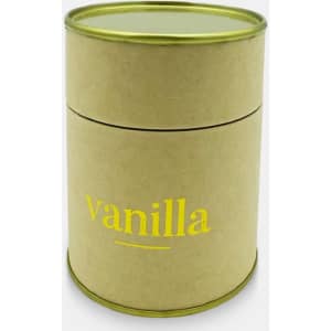 A small, round candle in a brown container with a gold lid, featuring "vanilla" in yellow text.