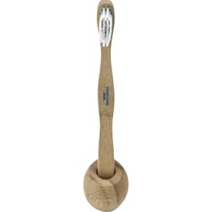 A bamboo toothbrush with a natural wooden handle and white bristles, placed in a circular holder.