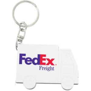 A white keychain shaped like a delivery truck, featuring a logo.