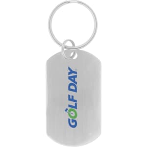 A silver dog tag keychain featuring a logo, attached to a metal ring.