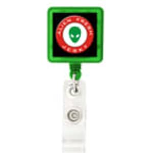 A green rectangular badge holder with a clear strap and a logo displayed in the centre.