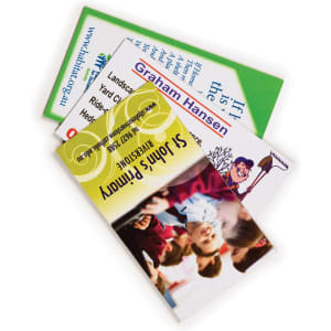 A stack of rectangular magnets in various colours, featuring different images and a logo on one magnet.