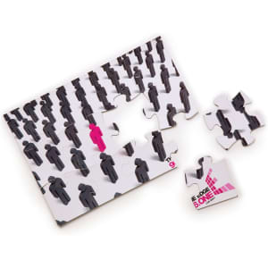 A5 jigsaw puzzle featuring a design of black figures with one pink figure, alongside several loose pieces.