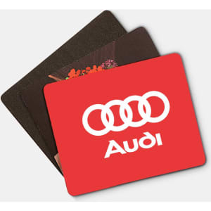 A set of three mouse mats in various colours, including a red one with a logo and two in darker tones.