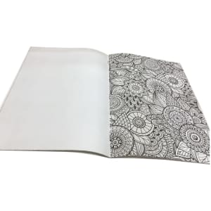 An open A4 colouring book featuring intricate black and white floral patterns on one page, with a blank page on the other.