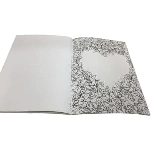 A5 colouring book with intricate floral designs on one page, featuring a heart-shaped outline. The pages are blank inside.