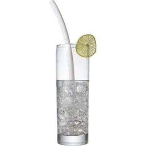 A clear glass filled with ice and water, featuring a white reusable silicone straw and a slice of lime.