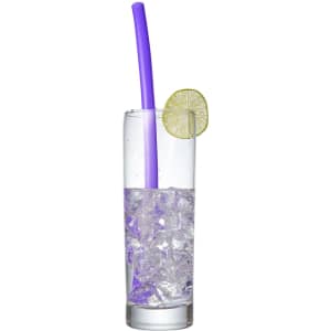 A drink bottle filled with ice water, featuring a purple reusable silicone straw and a slice of lime.