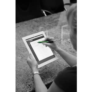 A stylus pen in green is being used on a tablet, with a person’s hand visible. The background features a textured surface.