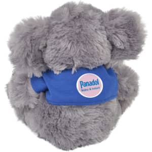 A soft grey plush koala with a blue shirt, featuring a circular logo on the front.
