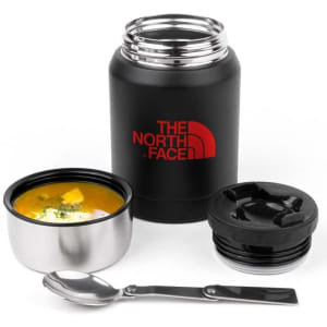 A drink bottle in matte black with a red logo, accompanied by a stainless steel bowl, lid, and spoon.