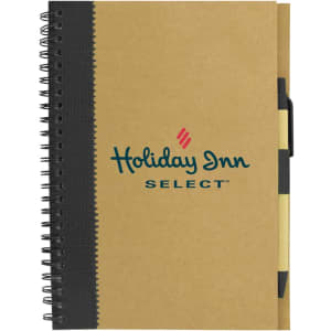A recycled paper notebook with a brown cover, black spiral binding, and a pen attached. It features a logo on the front.