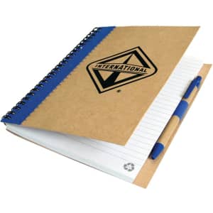 A recycled paper notebook with a brown cover, blue spiral binding, and a pen attached. It features a logo on the front.