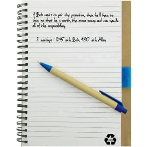 A recycled paper notebook with a brown cover, spiral binding, and a blue pen resting on it.