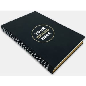 A black spiral notebook with a circular logo on the cover, featuring a shiny gold accent.