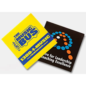 Two vinyl stickers in bright yellow and black, featuring distinctive logos and designs. Each sticker measures 75 x 75mm.
