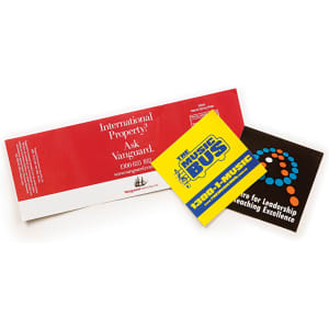 A collection of two vinyl stickers: a yellow and blue sticker with text, and a black sticker with a logo.
