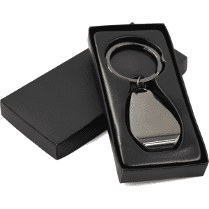 A gunmetal keychain with a bottle opener feature, presented in a black box.