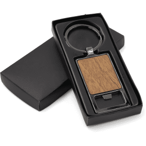 A rectangular keychain with a wooden panel, presented in a black box. The keychain has a metal ring and a sleek design.
