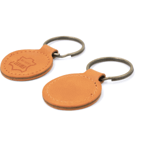 A tan recycled leather keyring with a metal keychain, featuring a branded logo on one side.