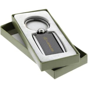 A sleek carbon fibre keychain in a gift box, featuring a branding logo and metallic accents.