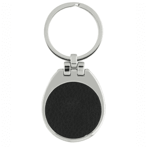 A silver keychain with a teardrop shape and a black textured surface.