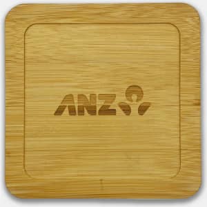 A bamboo coaster featuring a square shape with a logo engraved in the centre.