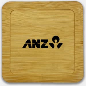 A bamboo coaster featuring a square shape and a black logo. The surface is smooth and polished.