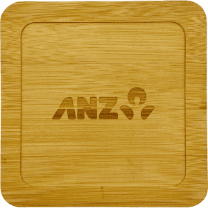 A bamboo coaster with a square shape, featuring an engraved logo. The colour is light brown.