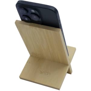 A bamboo phone stand in a natural finish, holding a smartphone at an inclined angle.