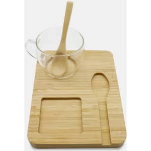 A bamboo tray featuring a glass cup with a wooden spoon, alongside a carved spoon-shaped and square indent.