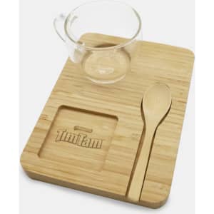 A bamboo tray set featuring a clear glass cup, wooden spoon, and a designated spot for a Tim Tam biscuit.