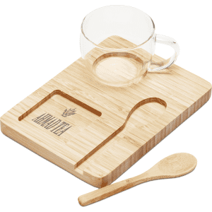A clear glass cup, a bamboo tray with a carved groove, and a wooden spoon, all in natural tones.