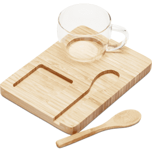 A bamboo tray with a clear glass cup and a wooden spoon. The set is minimalistic and natural in style.