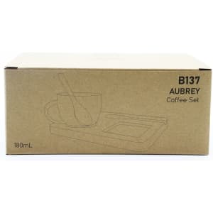A coffee and tea set in a cardboard box, featuring a cup, a spoon, and a tray. The box is a light brown colour.