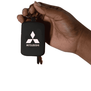 A black keychain power bank held in a hand, featuring a logo on the front and some keys attached.