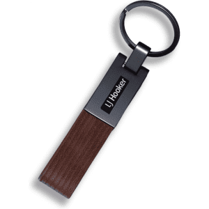 A PU strap keyring featuring a dark brown strap and a metallic ring, including a logo on the metal part.