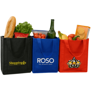 Three insulated grocery totes in black, blue, and red, filled with various groceries including fruits, vegetables, and a drink bottle.