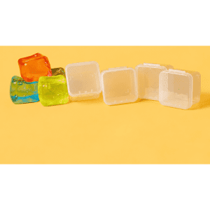 A row of clear plastic jelly cube sensory toys in orange, blue, and green against a yellow background.