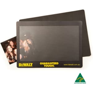 A natural rubber counter mat featuring a smooth black surface and a logo at the bottom, with a small photo included.