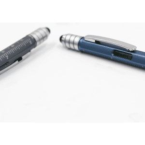 A blue and silver pen with a ruler and a textured grip, featuring a clip and a branding logo.
