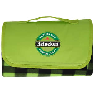 A green picnic blanket with a checkered black and green underside and a logo on the top.