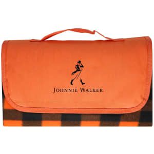 An orange picnic blanket with a checkered design and a logo on the front.
