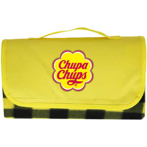 A yellow picnic blanket with a checkered black pattern, featuring a logo on the front.