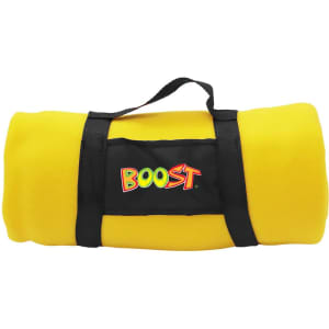 A rolled yellow blanket with a black strap and a logo. The blanket is vibrant and plush.
